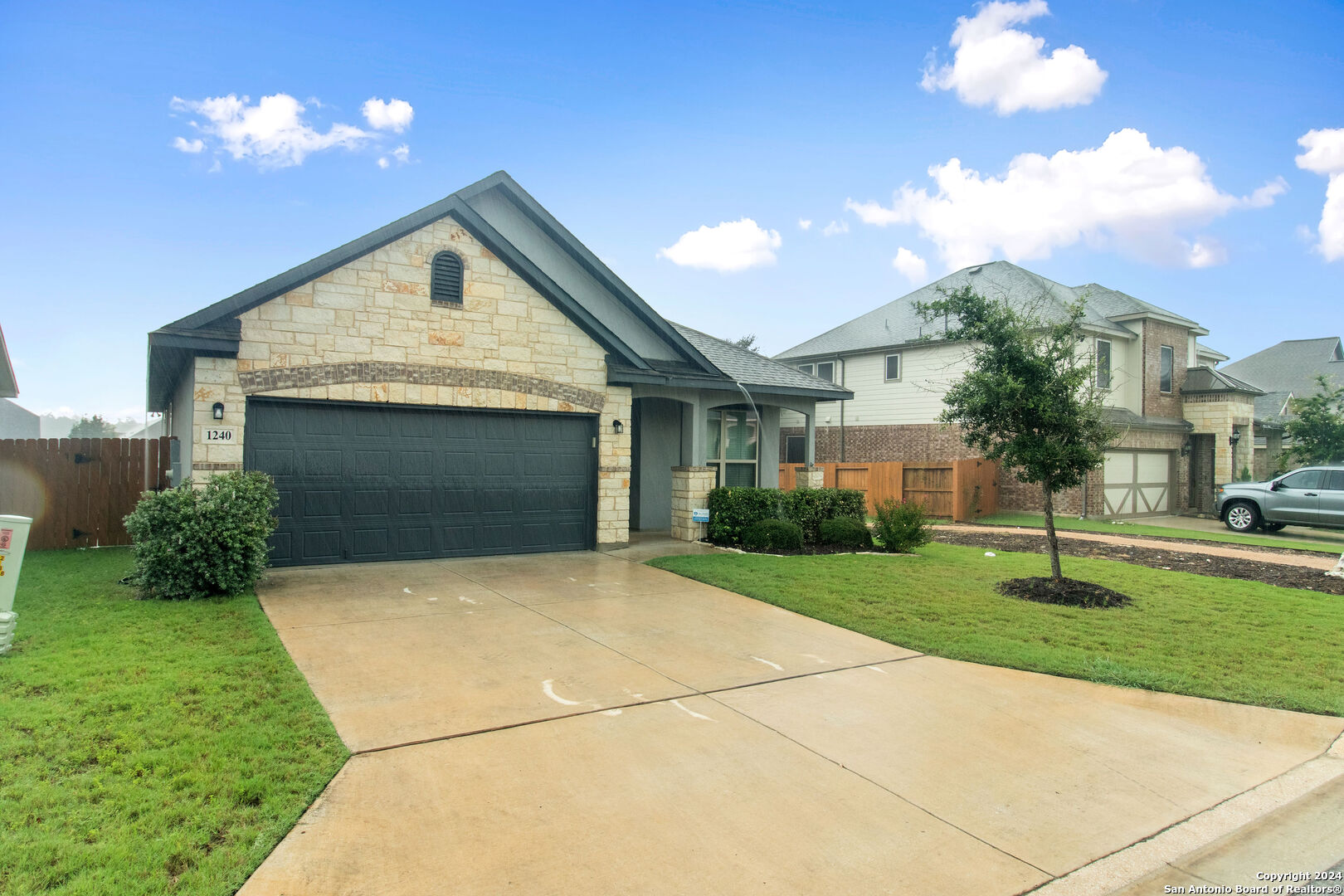 a front view of a house with a yard and garage