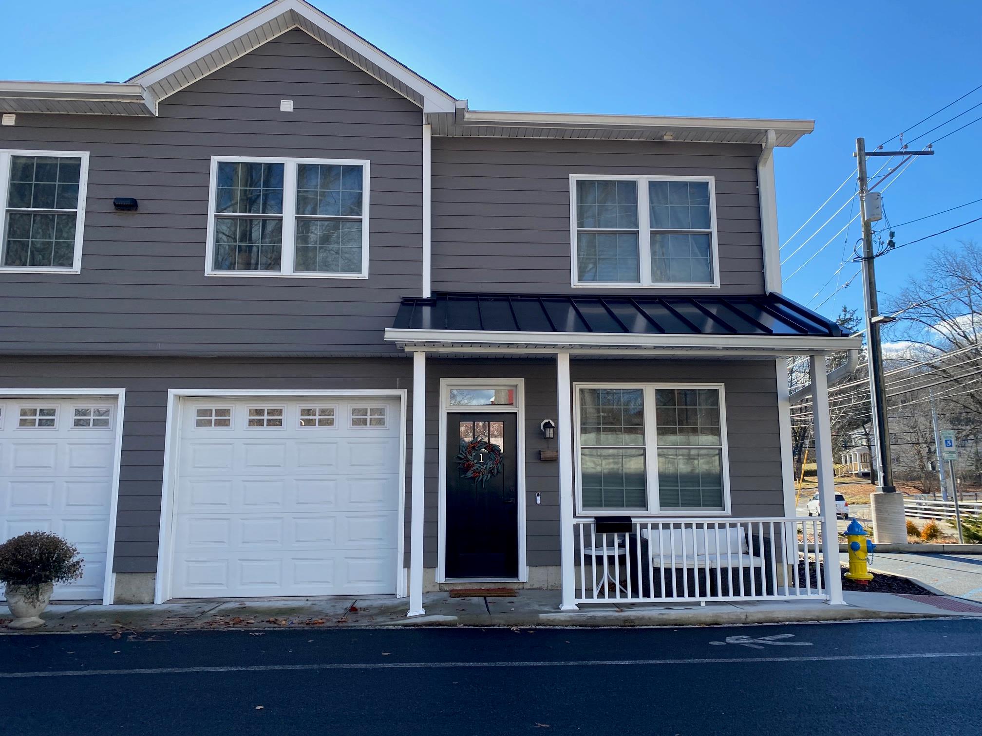 View of front of house featuring covered porch and a garage