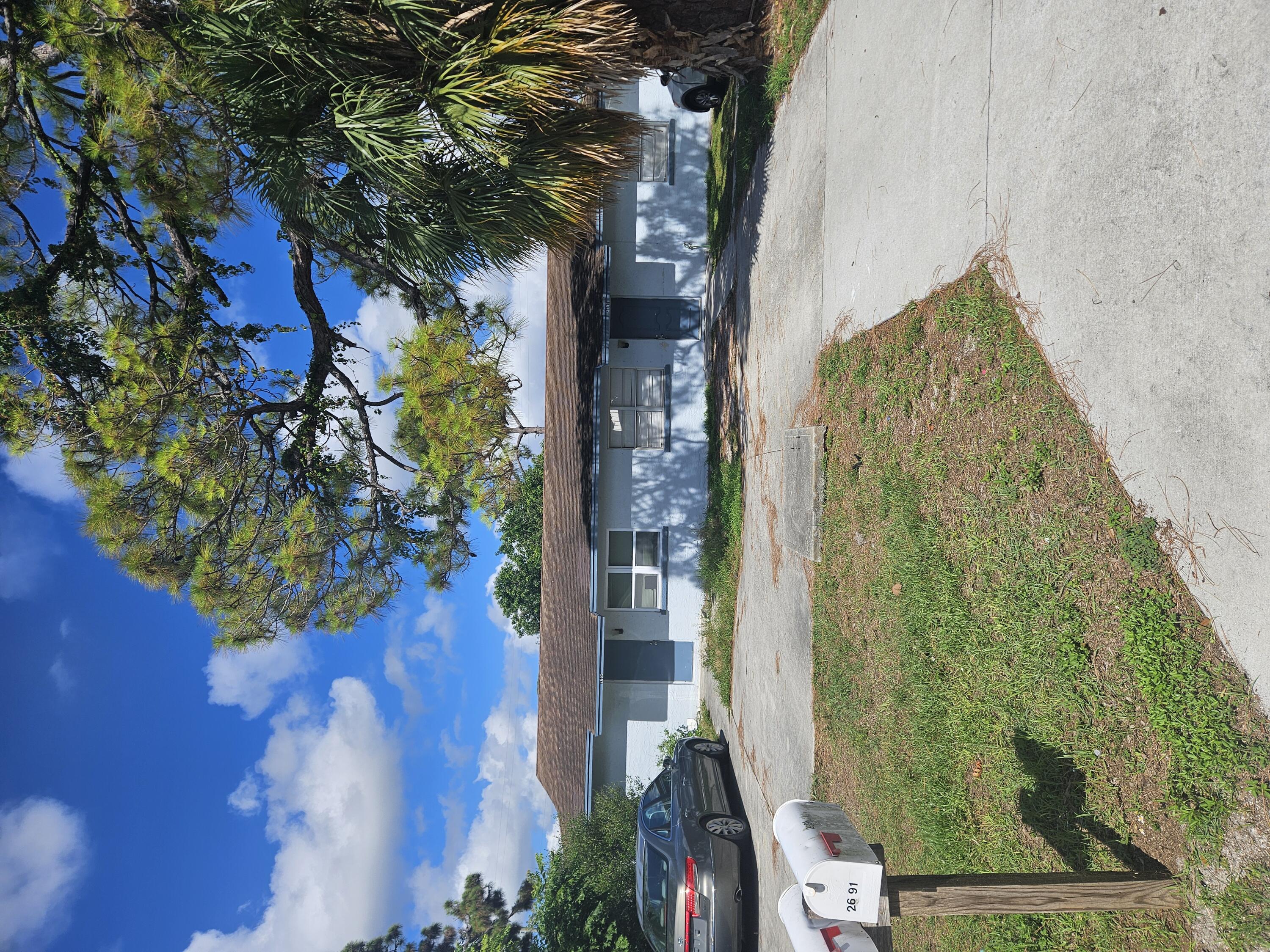 a front view of house with yard and outdoor seating