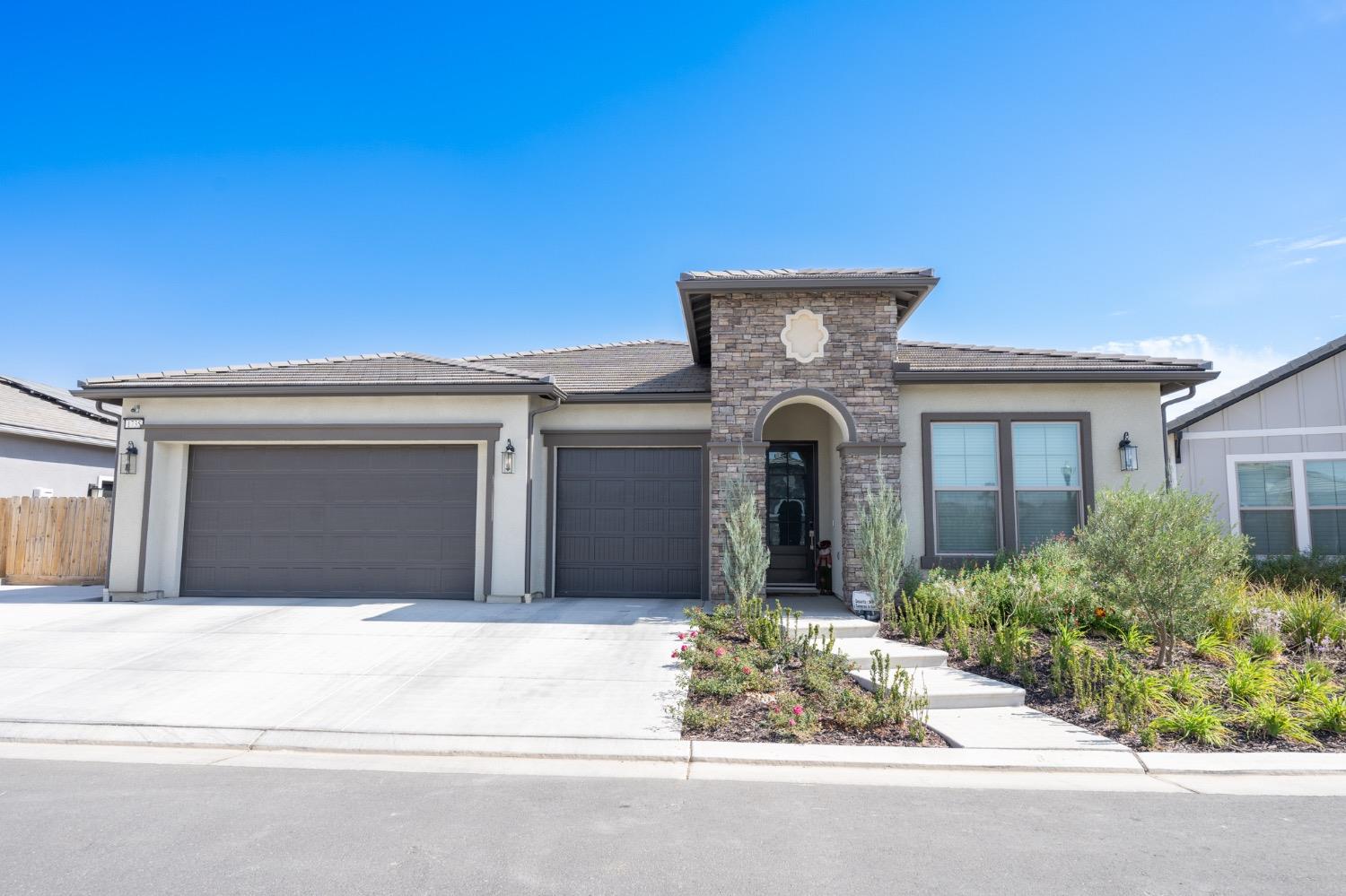 a front view of a house with garage