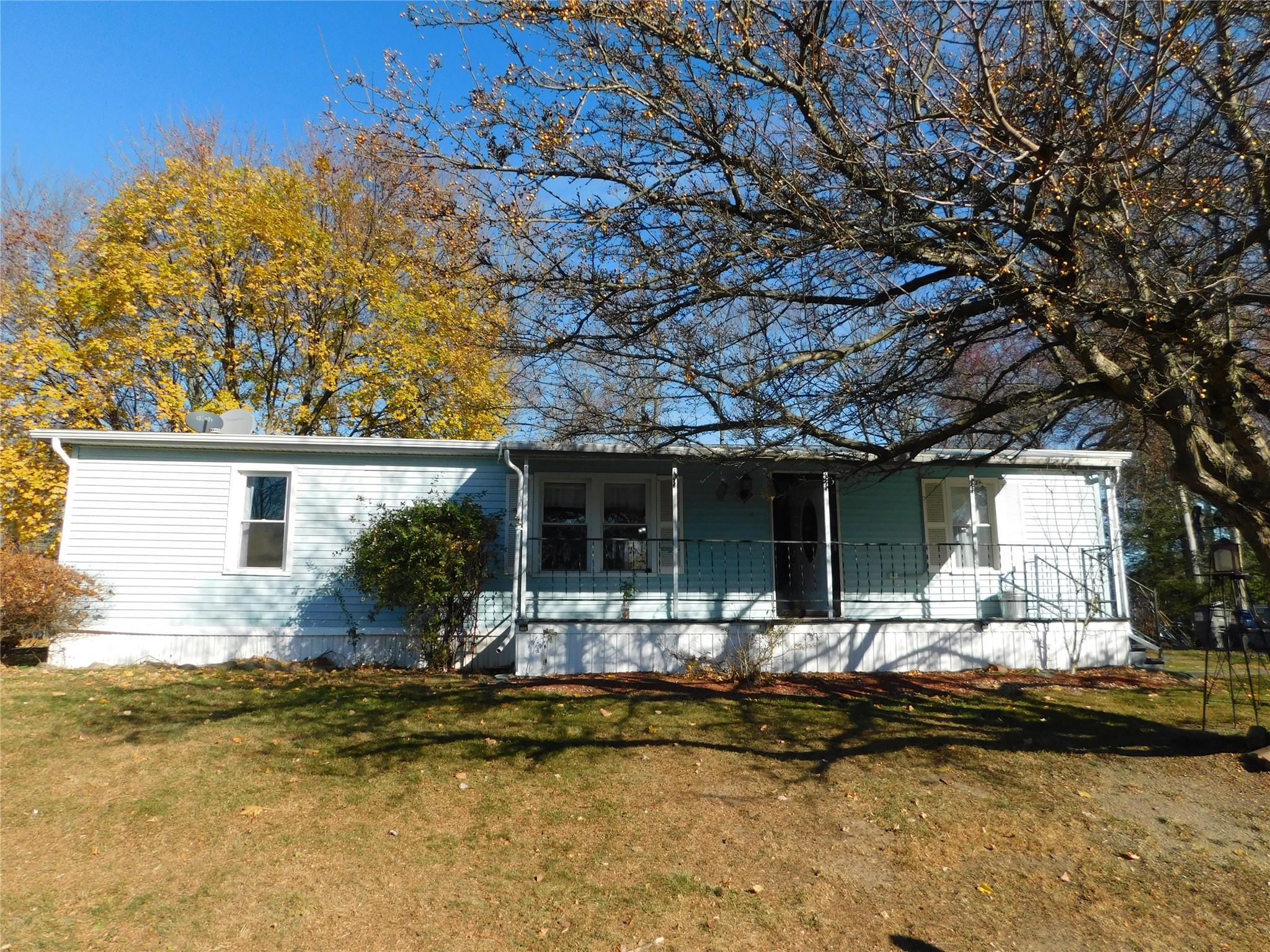 Ranch-style home with a front yard and a porch