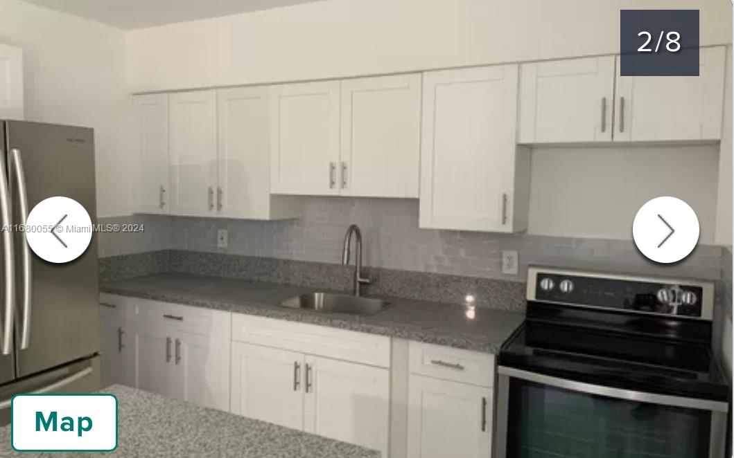 a kitchen with cabinets appliances and a counter space