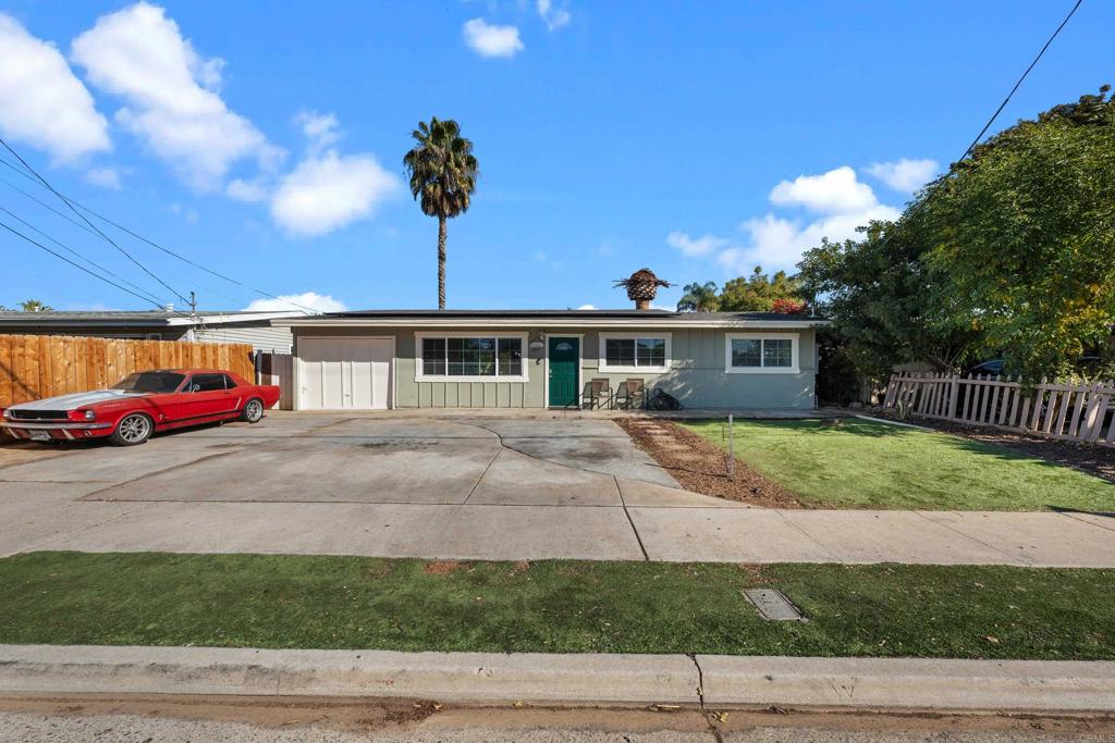 a front view of a house with a yard and a garage