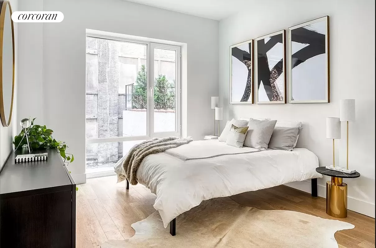 a bedroom with a bed and a potted plant