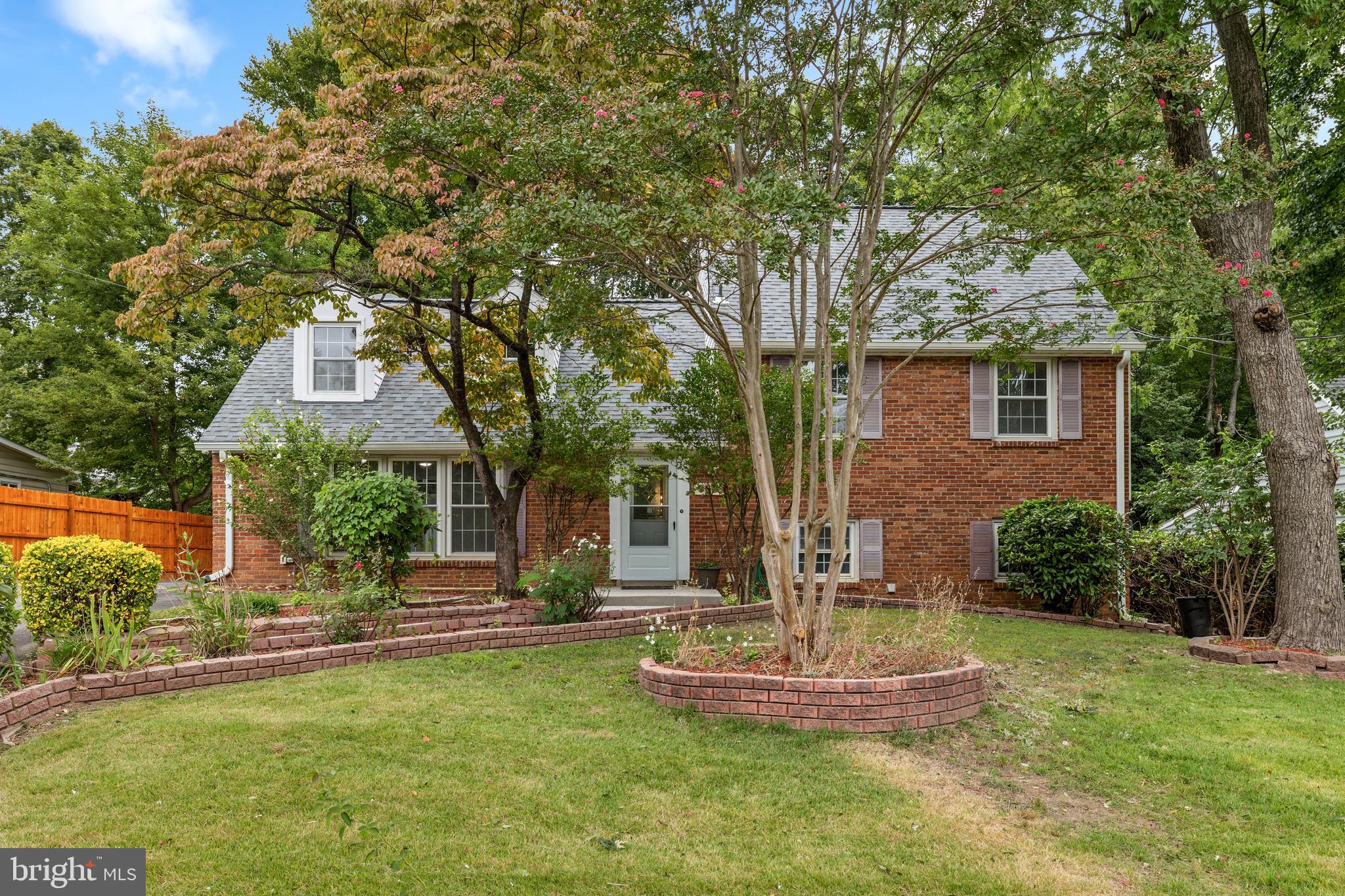 a front view of a house with a yard garage and fountain