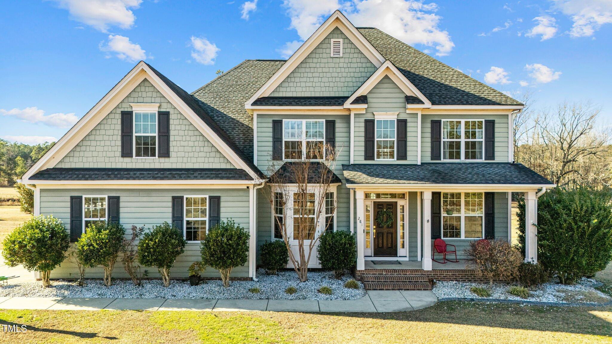 a front view of a house with yard porch and furniture