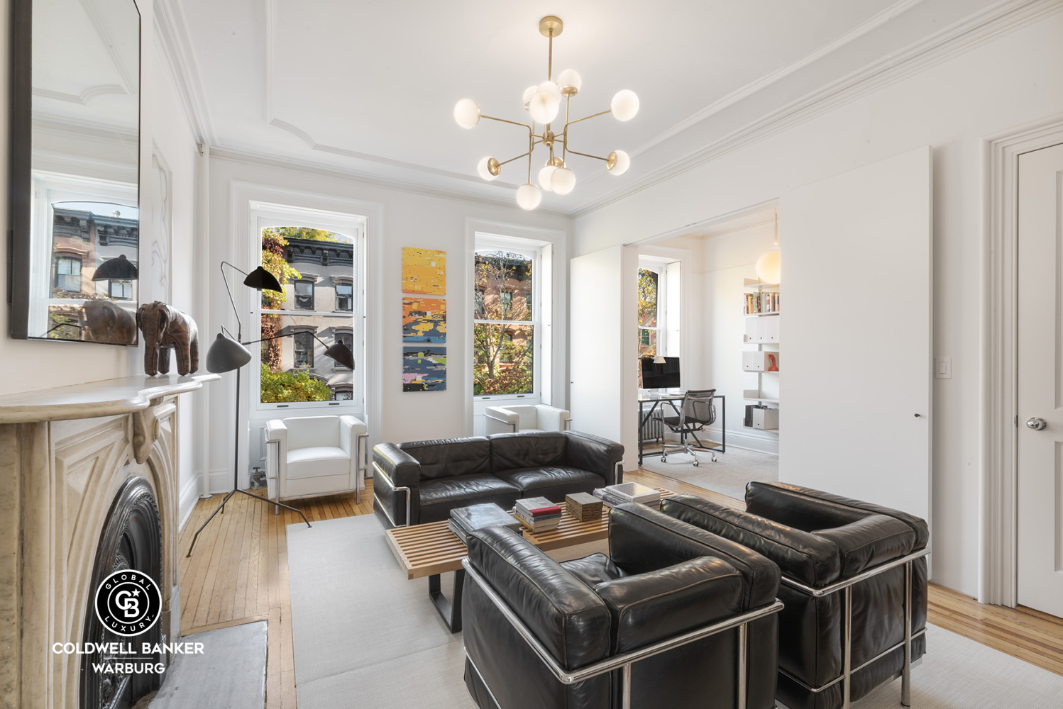 a living room with furniture and a chandelier