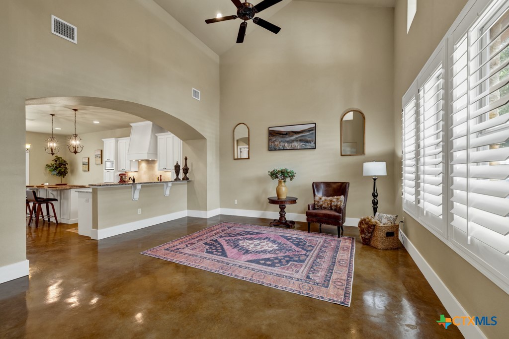 a living room with fireplace furniture and a table