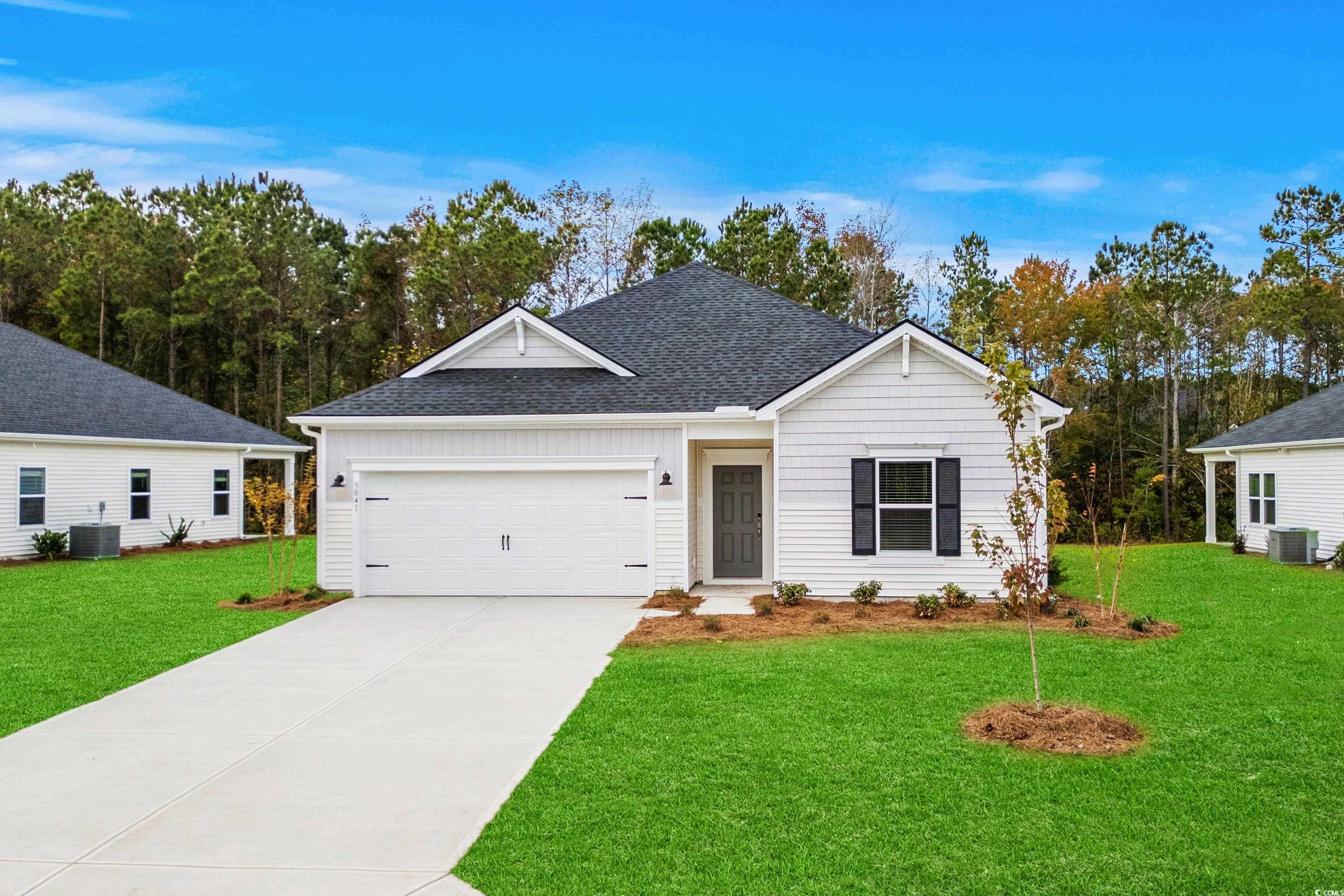 Single story home featuring a front lawn, a garage