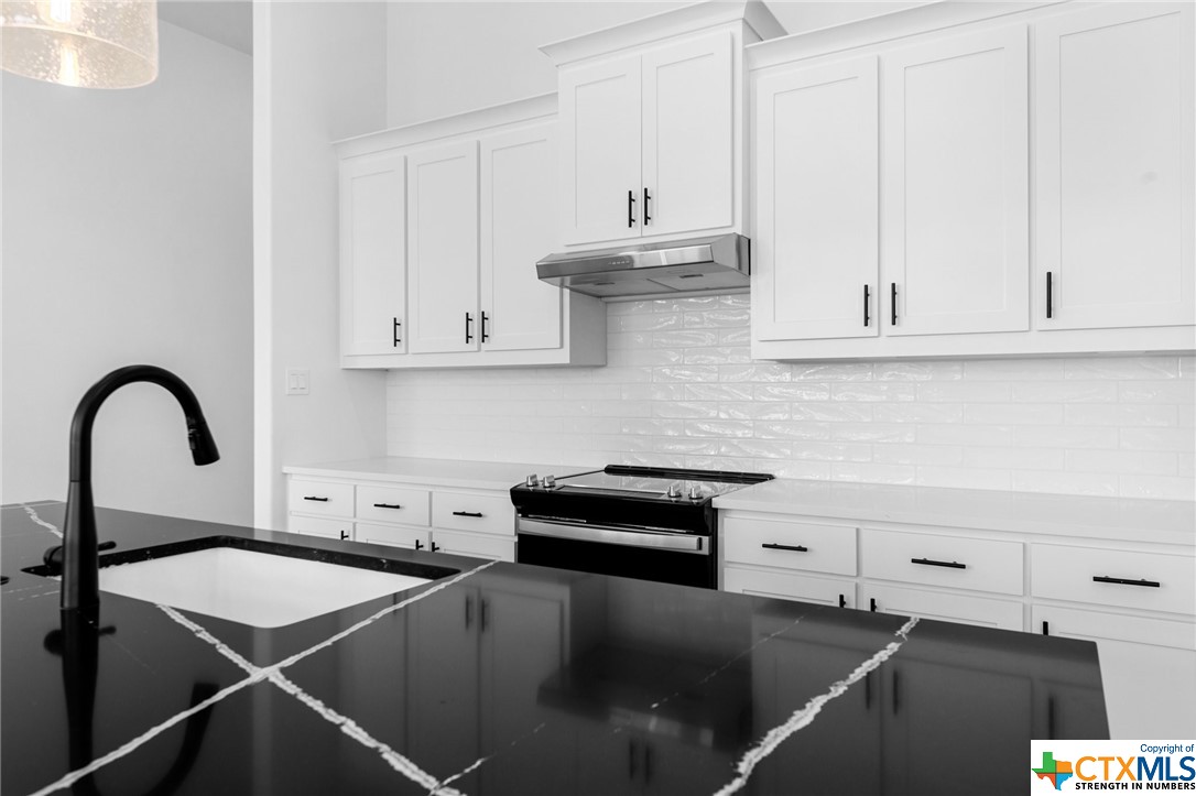 a kitchen with a sink and cabinets