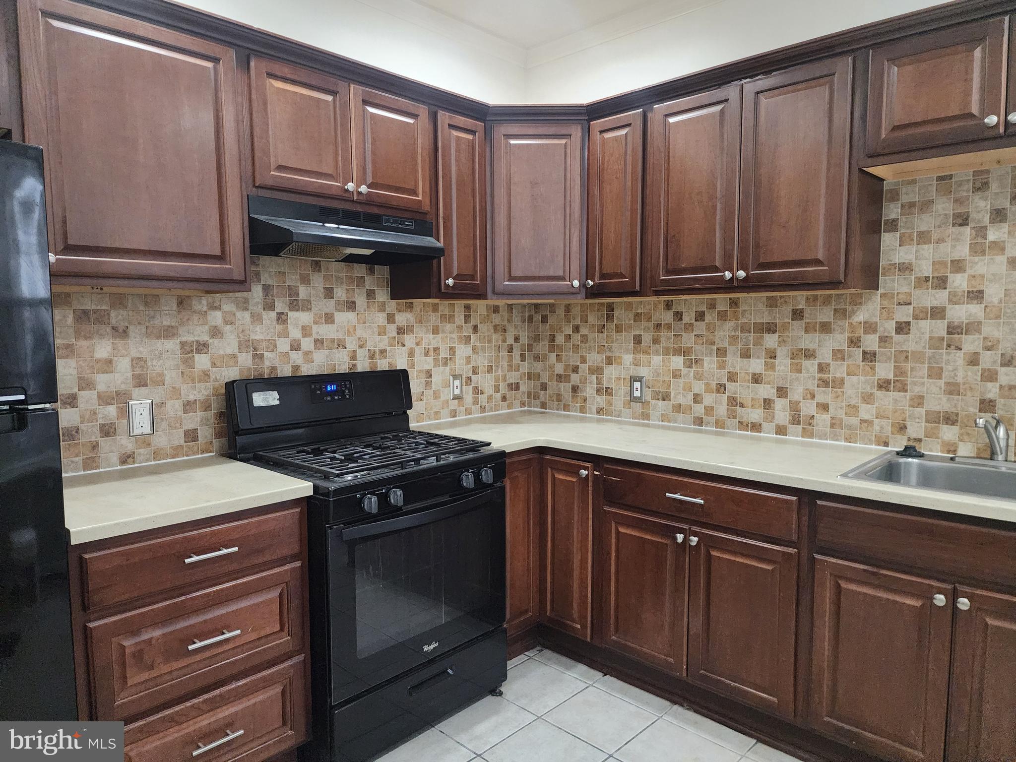 a kitchen with granite countertop wood cabinets and stainless steel appliances