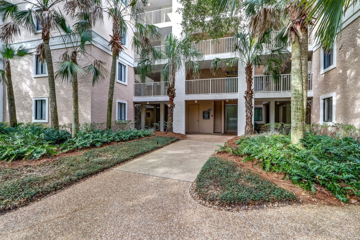 a front view of a multi story building with a yard