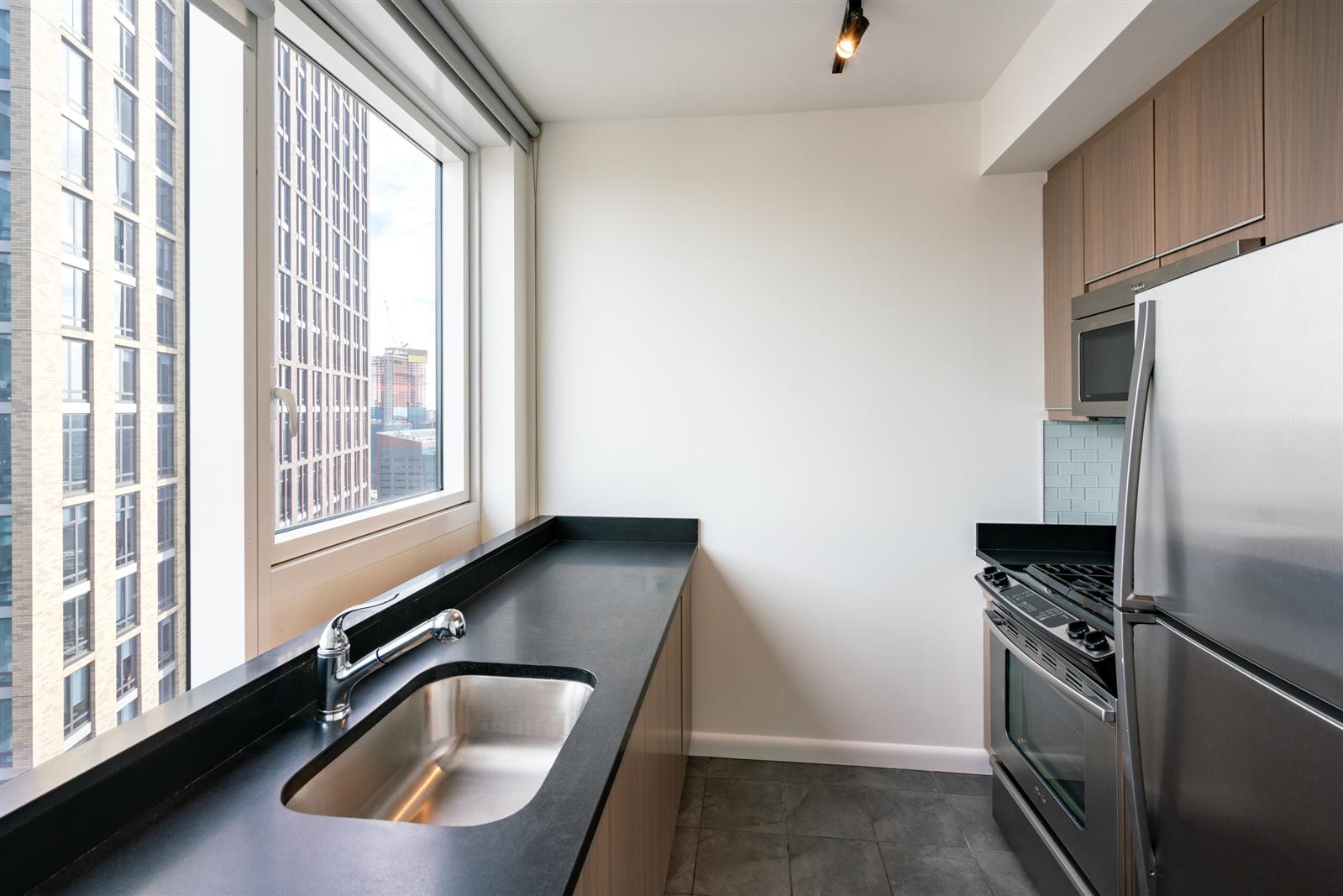 a kitchen with a refrigerator and a sink