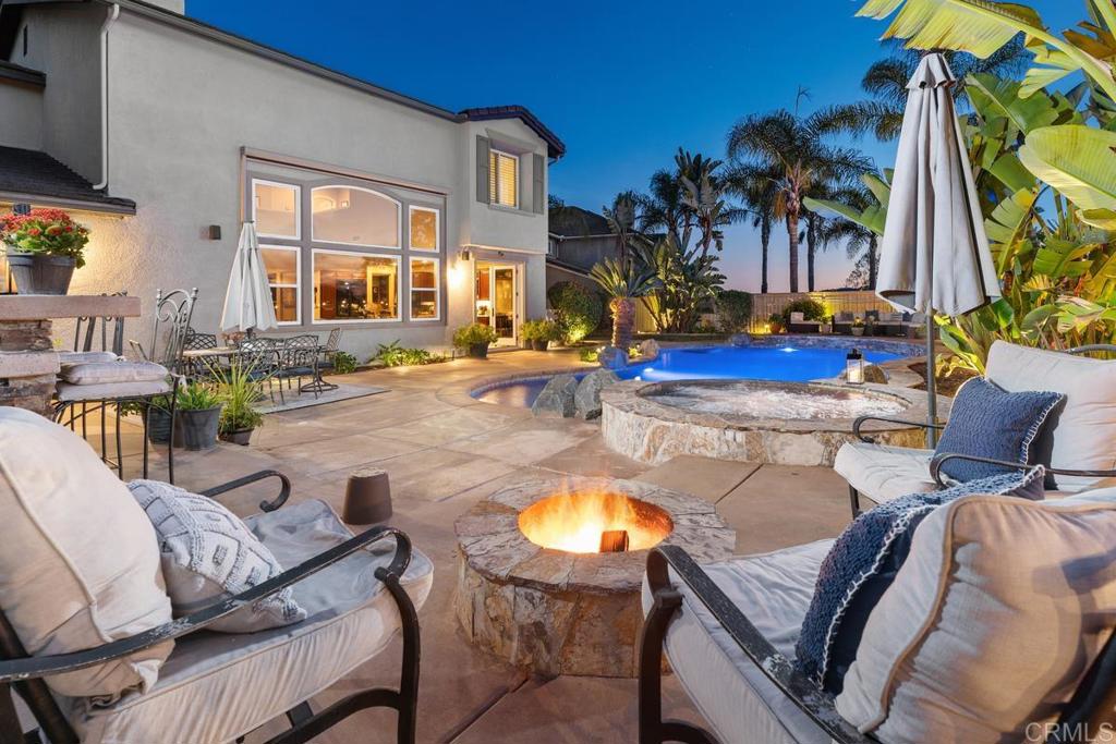 a view of a swimming pool with outdoor seating