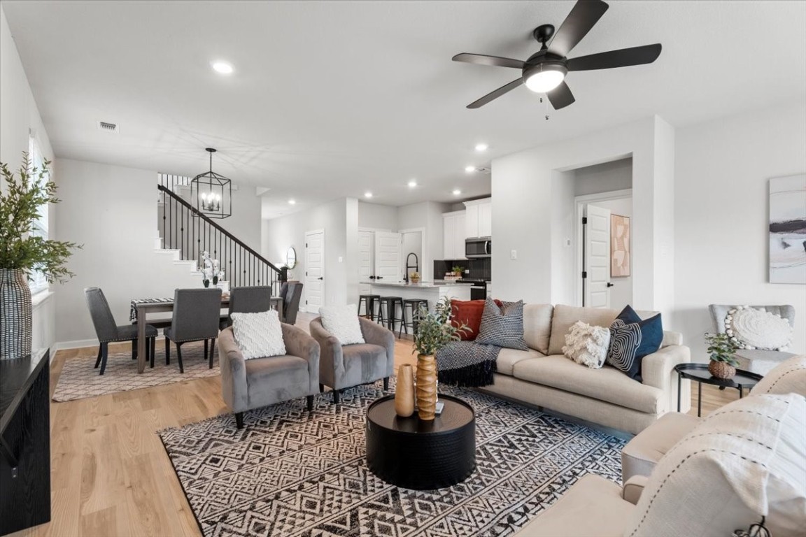 a living room with furniture and a view of kitchen