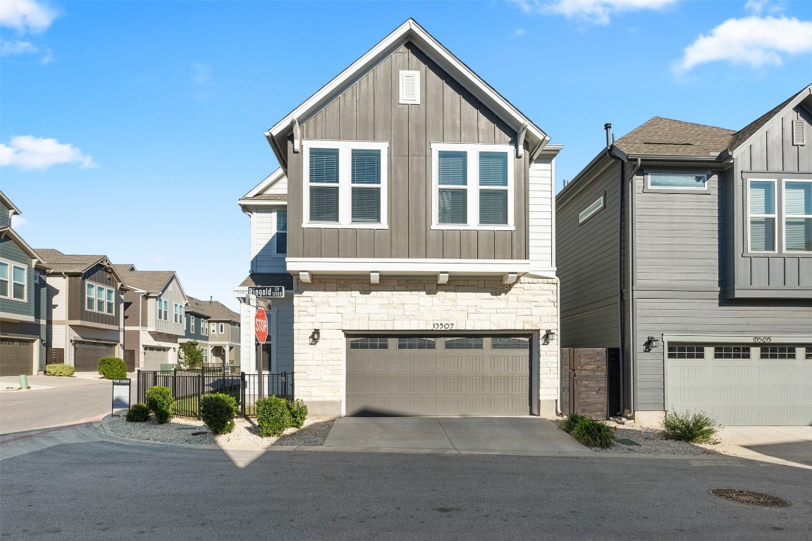 a view of a house with a yard and garage