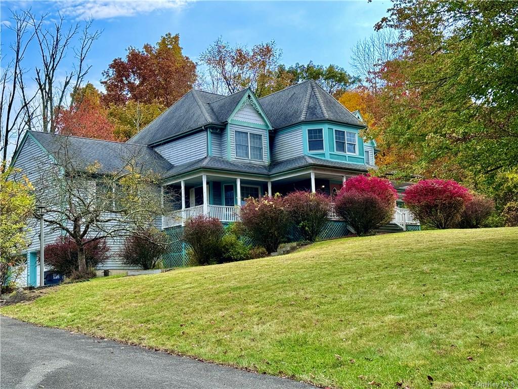 a front view of house with yard and green space