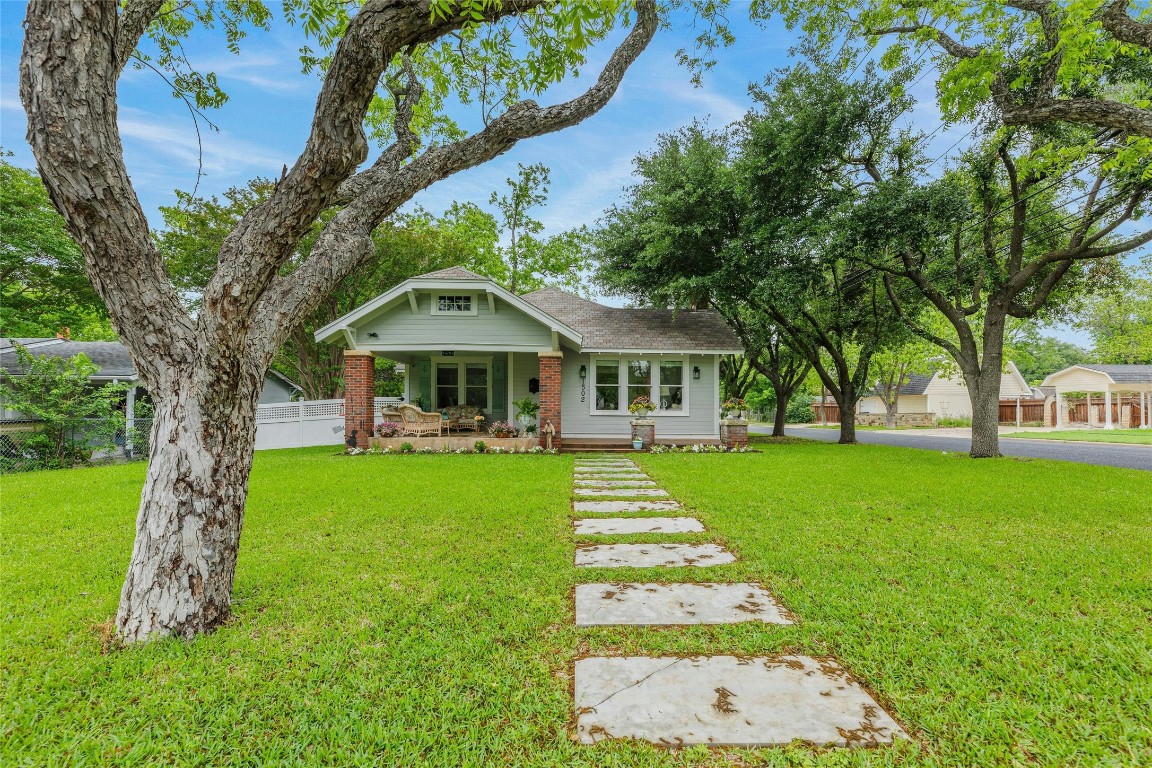 a front view of a house with garden