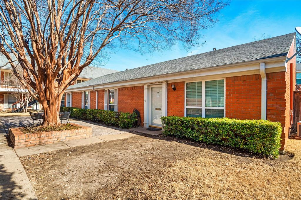 a view of a brick house with a yard