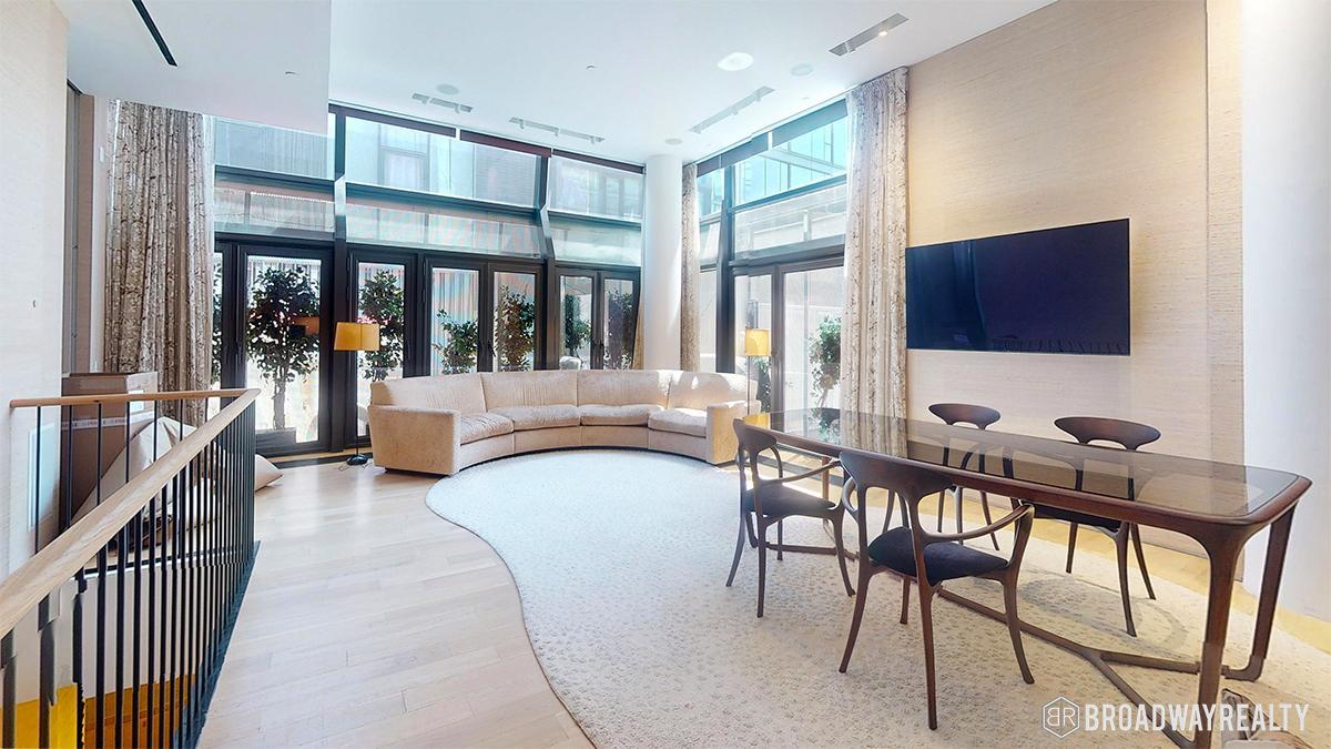 a view of a dining room with furniture and window