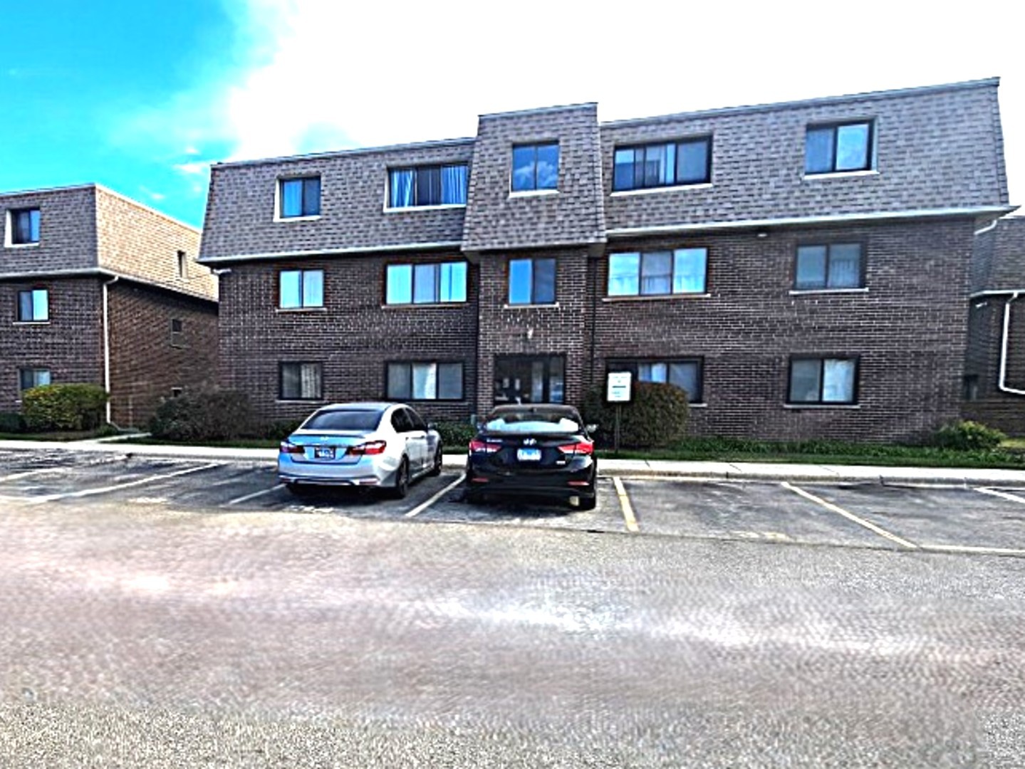 a car parked in front of a brick building