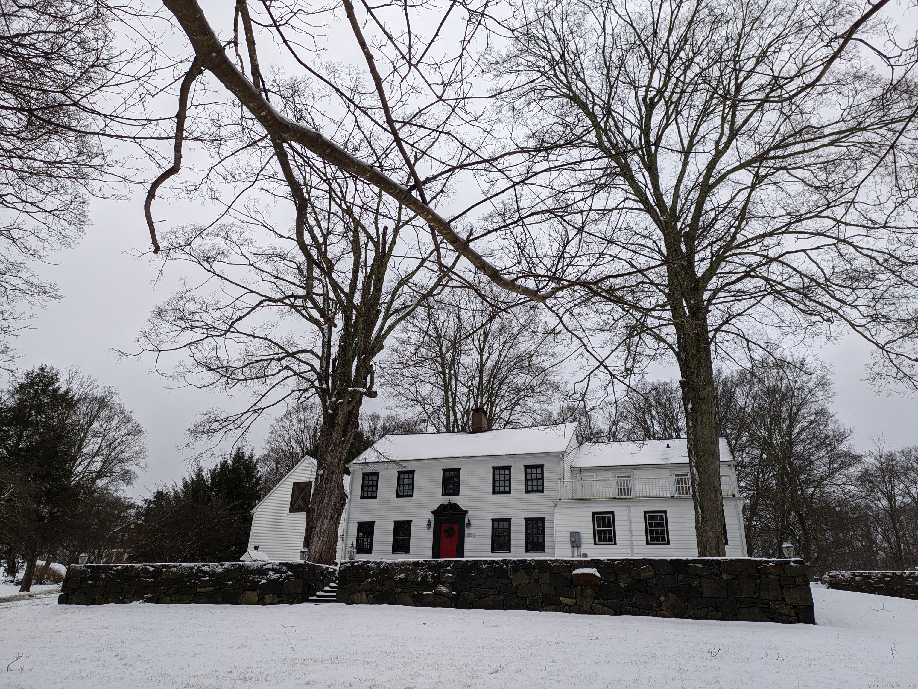 a front view of residential houses with yard and trees