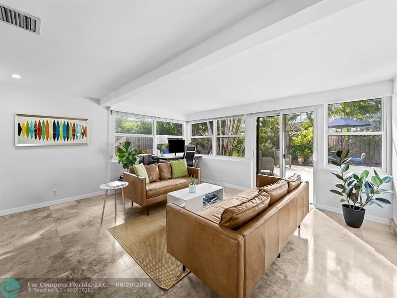 a living room with furniture and outdoor space