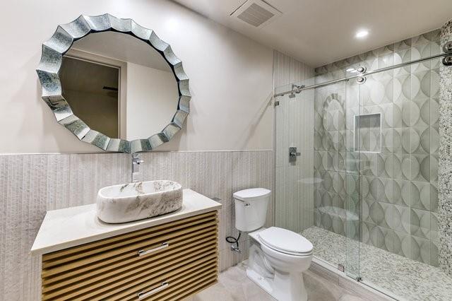 a bathroom with a sink toilet and a mirror