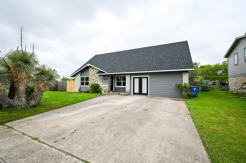 a front view of house with yard and green space