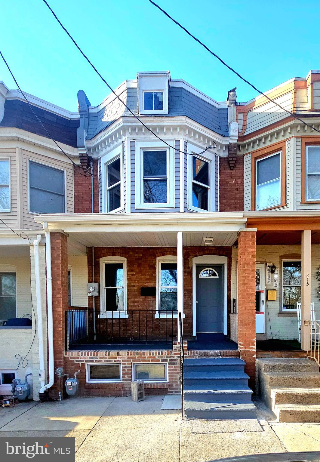 a front view of a residential apartment building with a yard