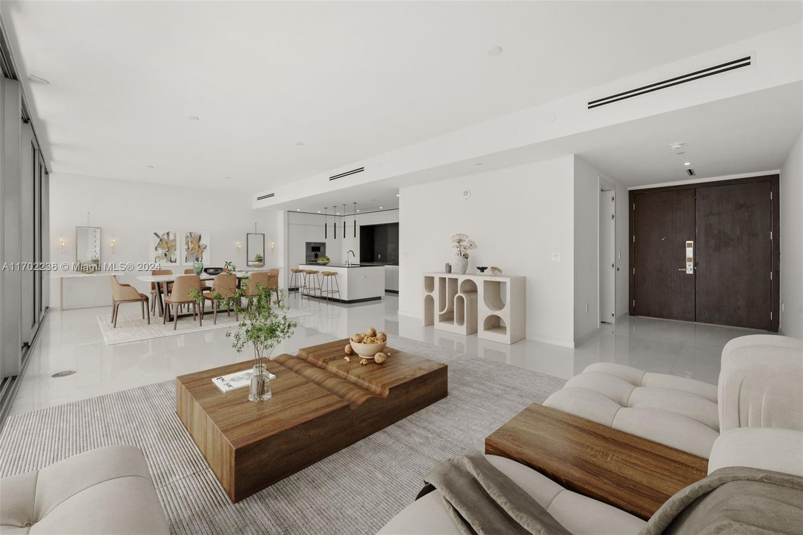 a living room with furniture and view of kitchen