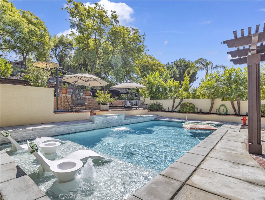 a view of a patio with furniture and a garden