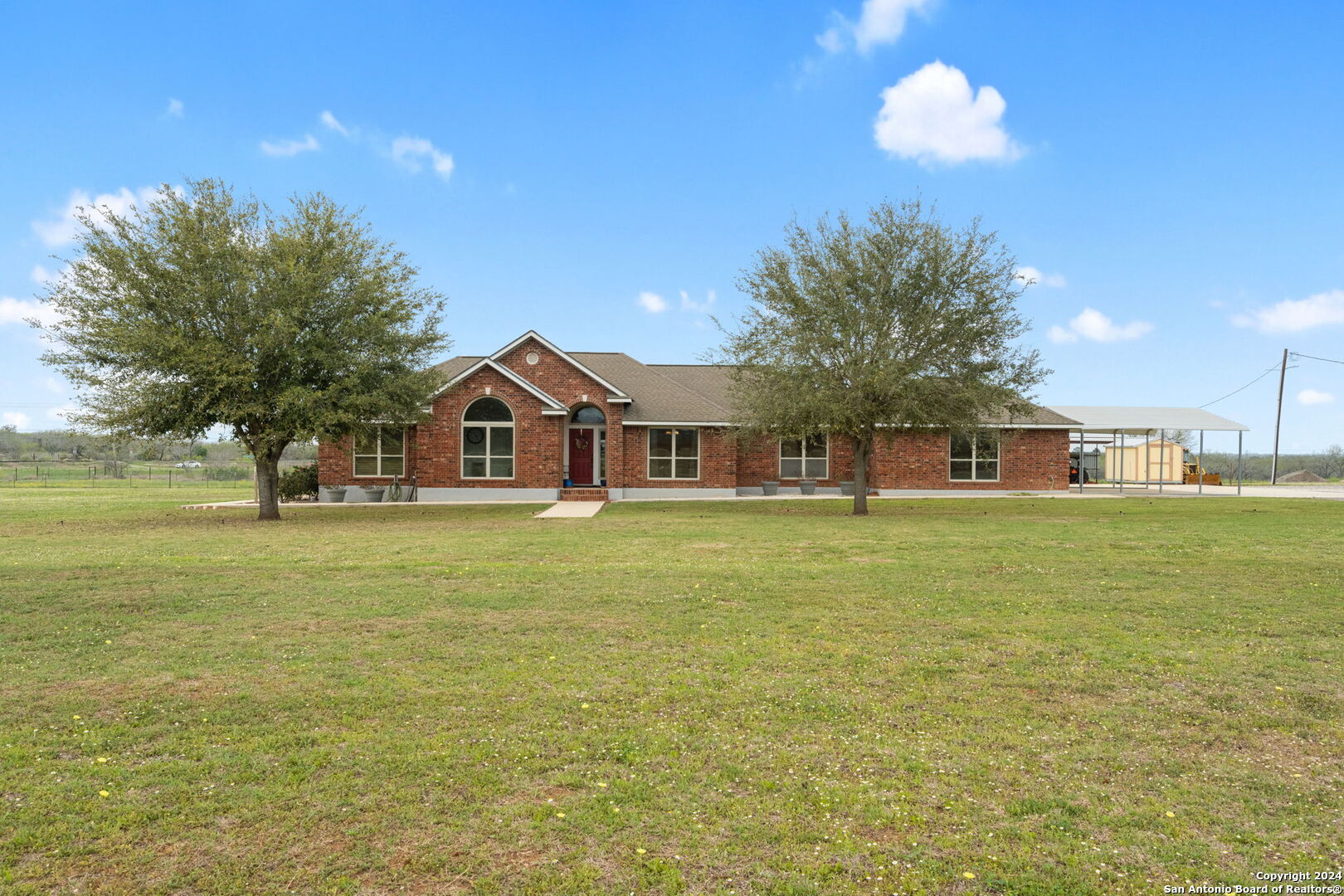 a front view of a house with a big yard