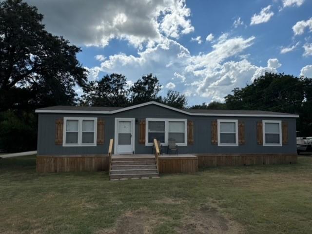 a view of house with a yard