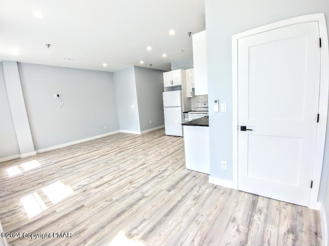 a view of a kitchen with wooden floor