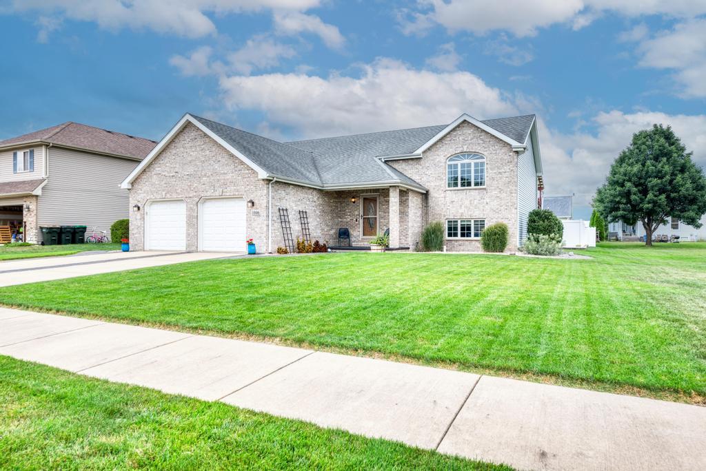 a front view of house with yard and green space