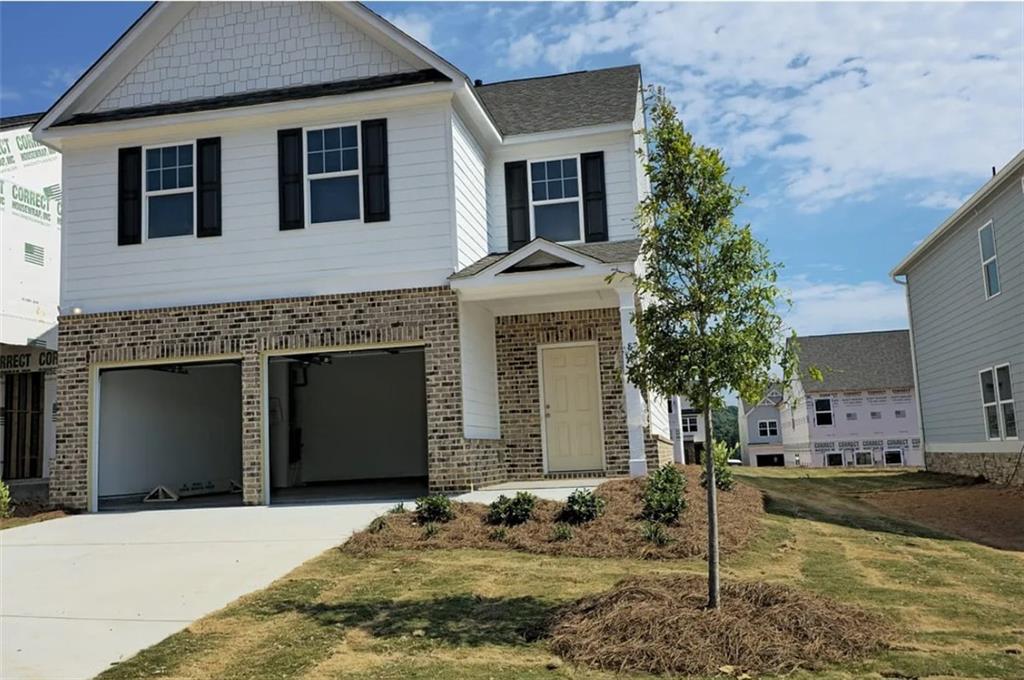 a front view of a house with a yard