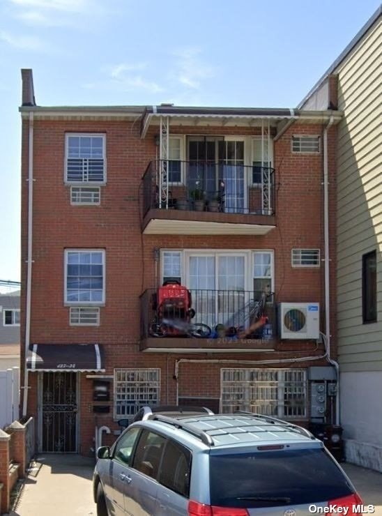 a front view of house and car parked