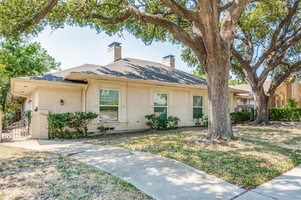 a house that has a tree in front of the house