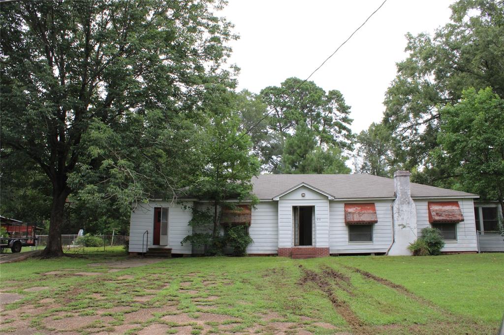 a front view of a house with a yard and a garage