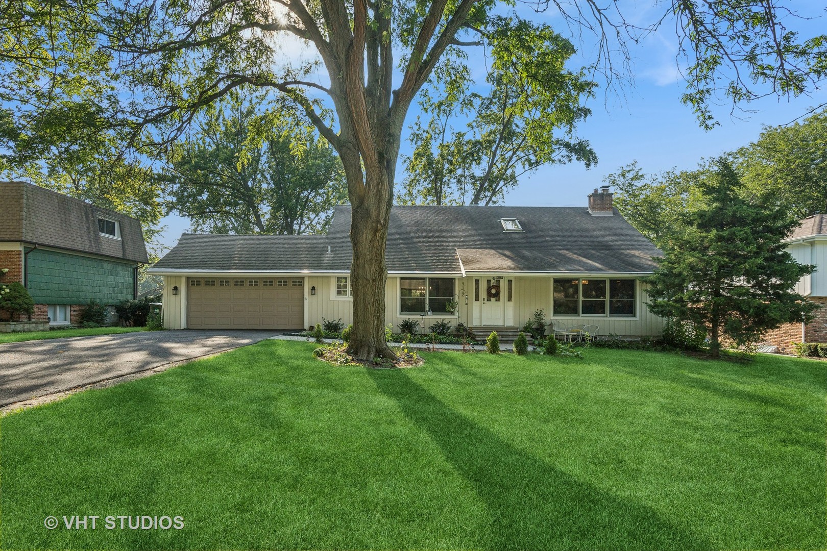 a view of a house with a yard and tree s