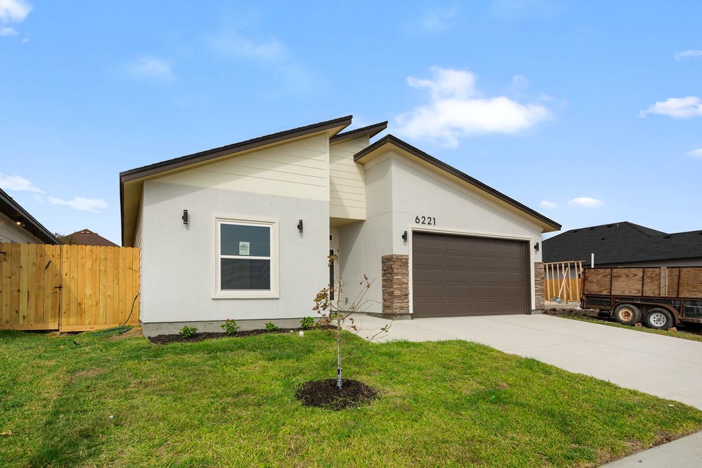 a front view of a house with a yard and garage