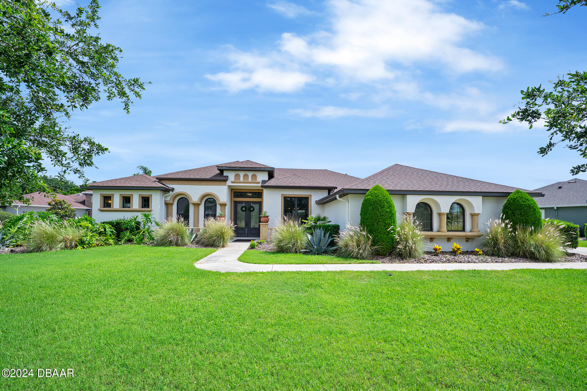 a front view of house with yard and green space