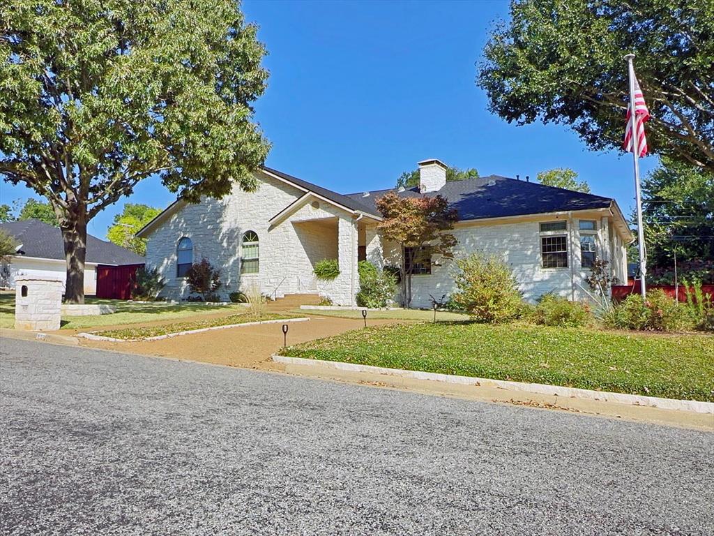 a view of a house with a yard and a garage