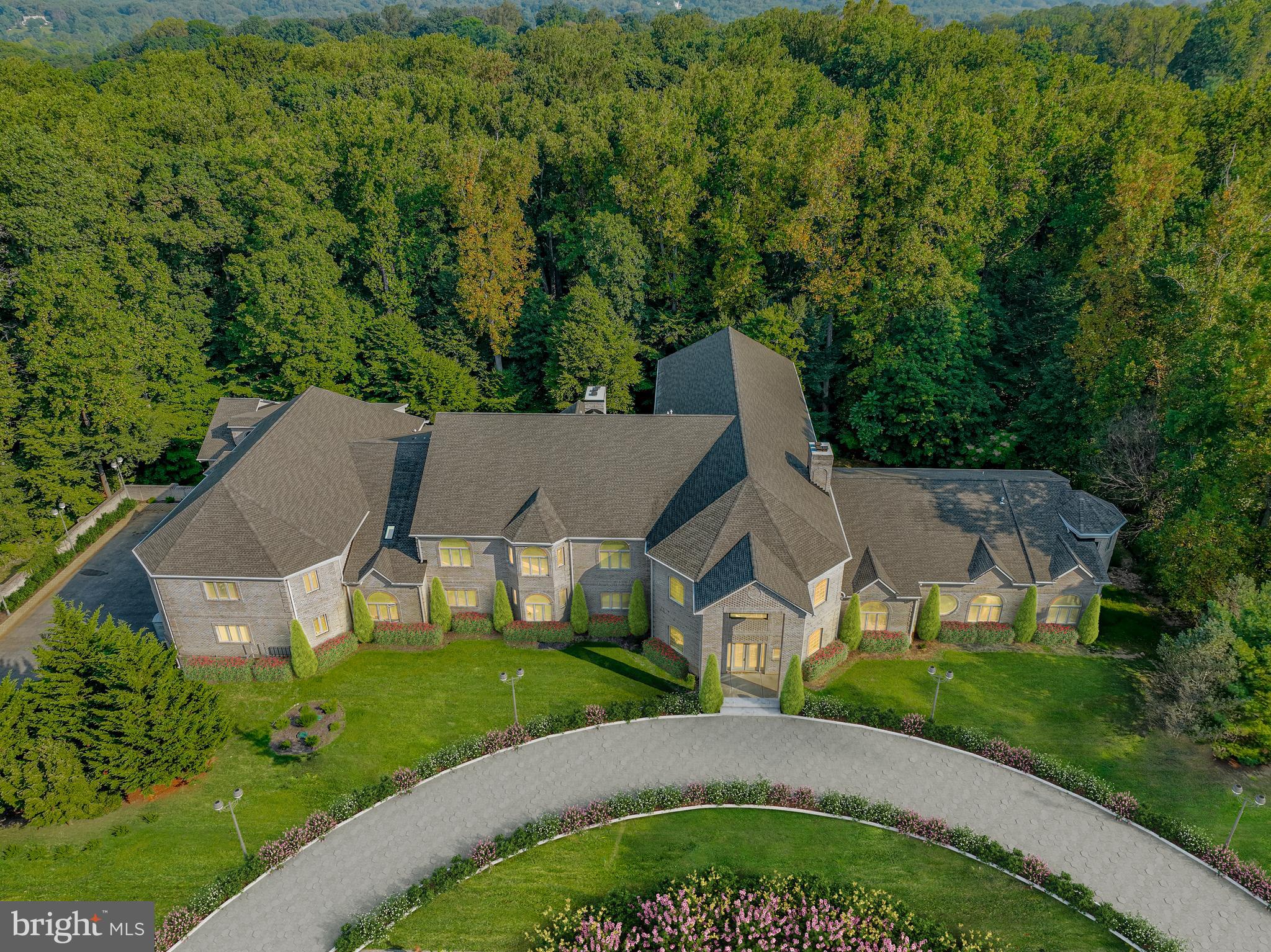 an aerial view of a house with swimming pool and garden