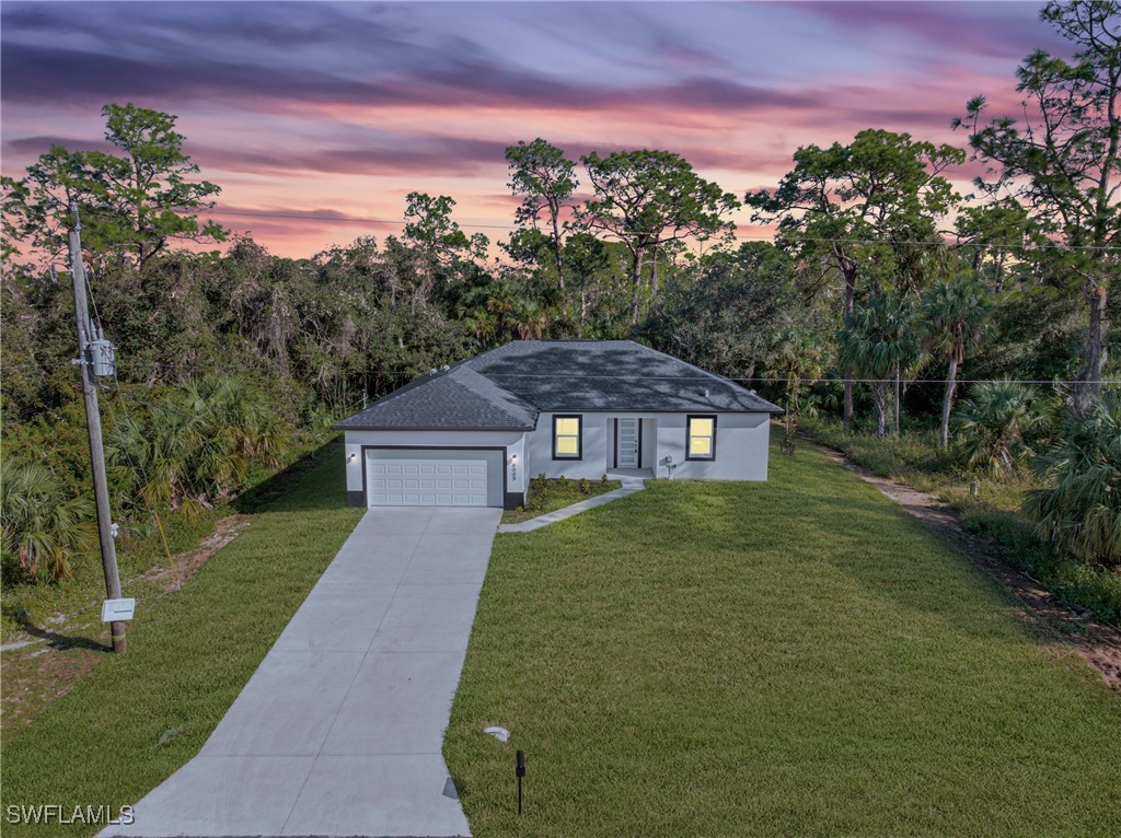 a view of a big yard of front of the house