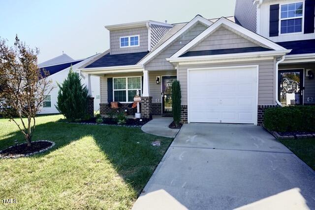 a front view of a house with a yard and porch