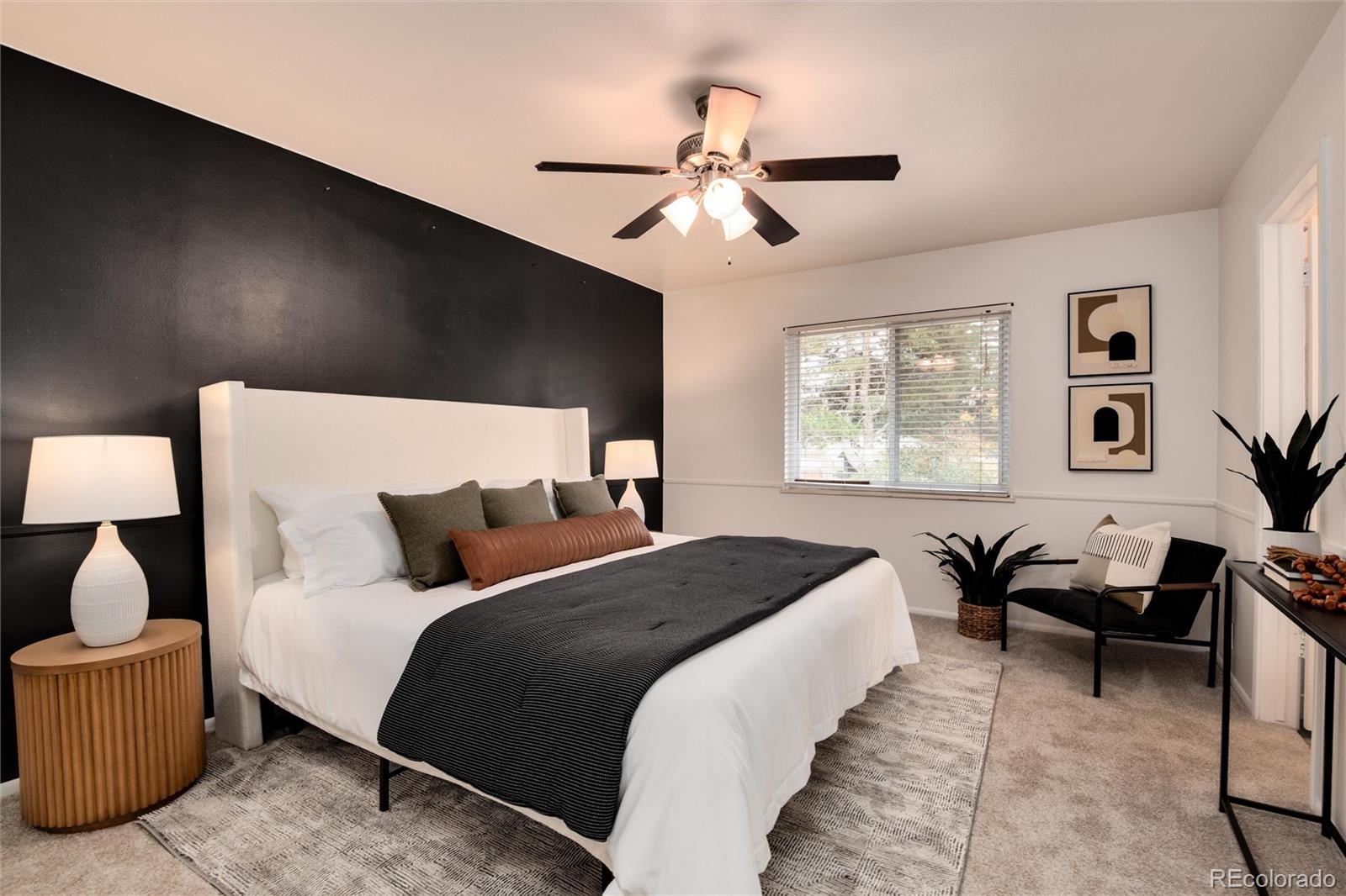 a bedroom with bed couch and window