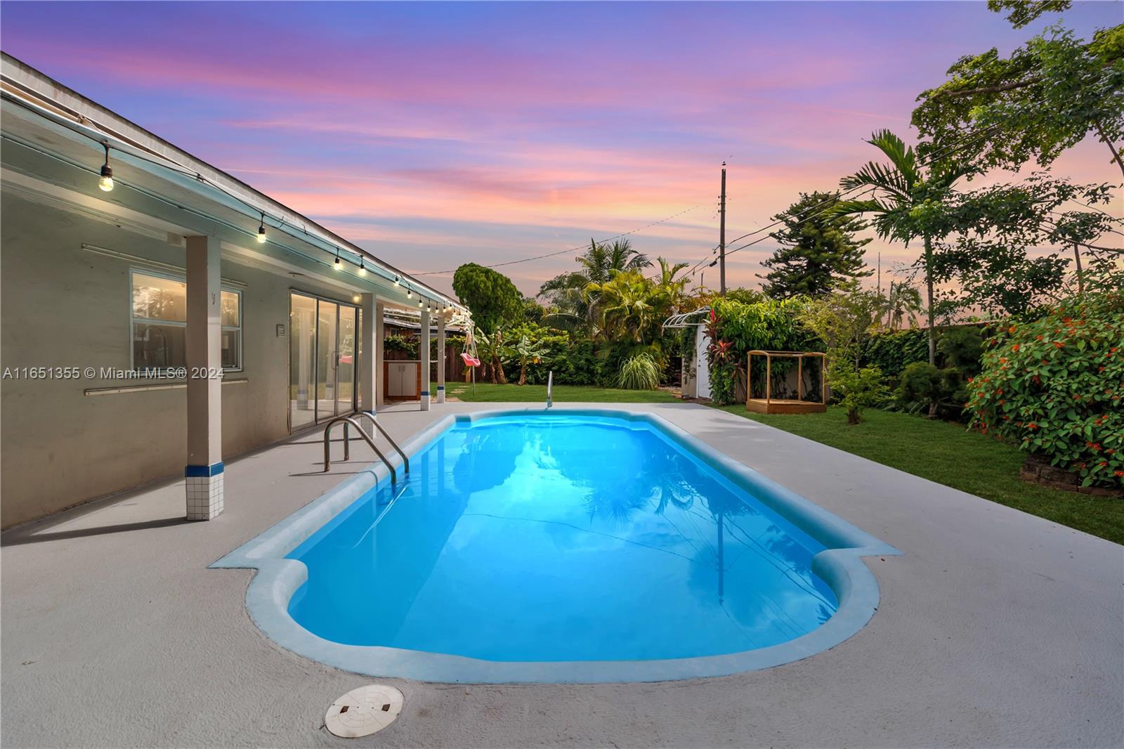 a view of a swimming pool with an outdoor seating