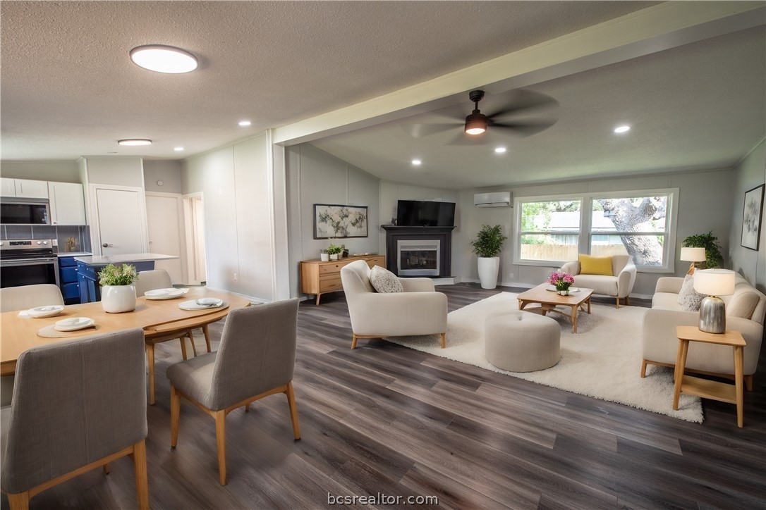 a living room with fireplace furniture and a wooden floor